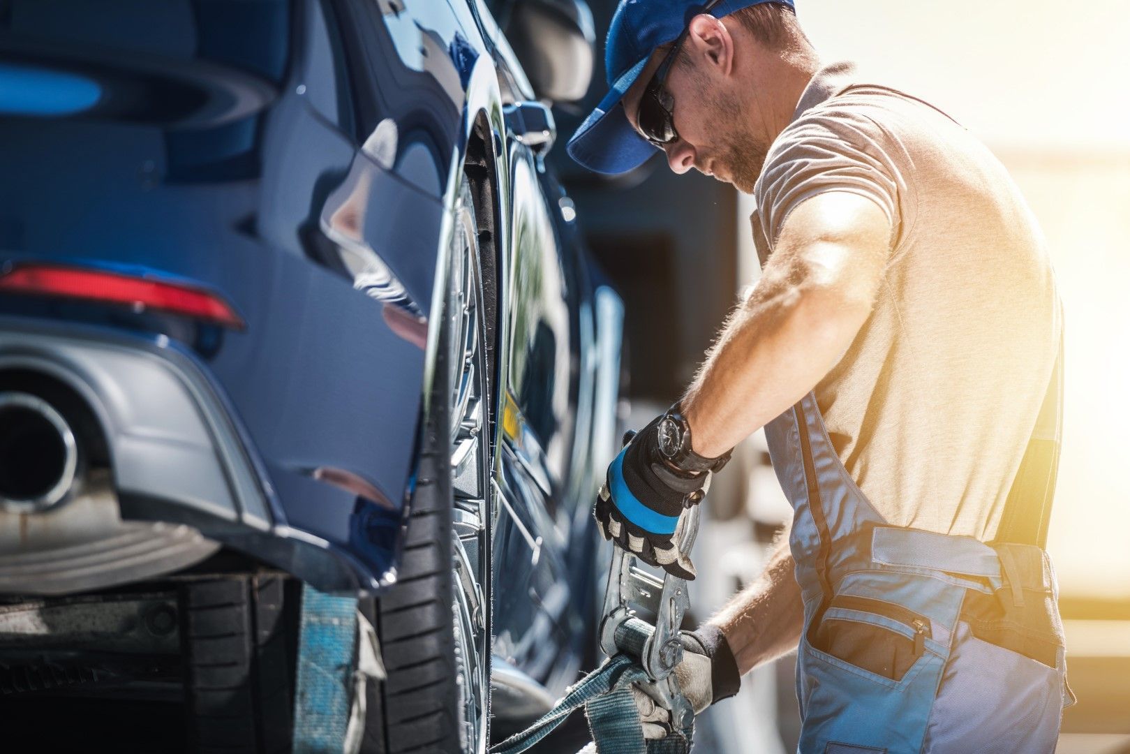 A man is working on a car in a garage.